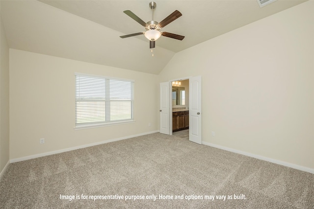 unfurnished bedroom featuring light carpet, ensuite bathroom, ceiling fan, and lofted ceiling