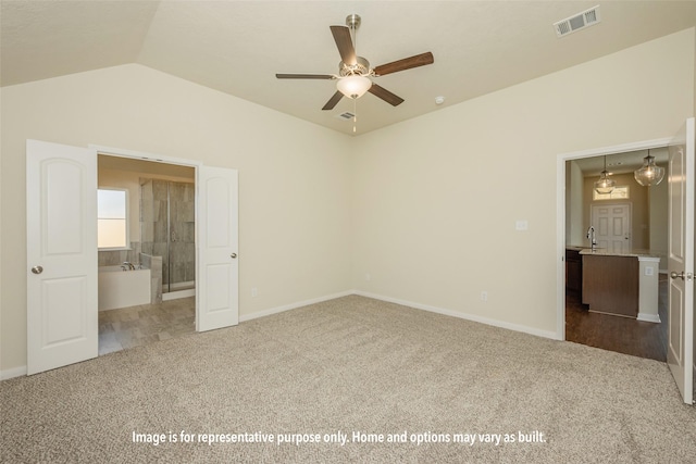 unfurnished bedroom featuring ceiling fan, sink, carpet floors, and lofted ceiling