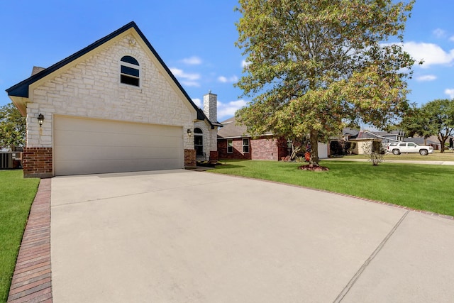 view of front of house with central AC, a front lawn, and a garage