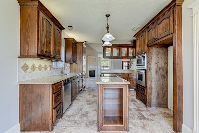 kitchen with appliances with stainless steel finishes, light stone countertops, a kitchen island, and backsplash