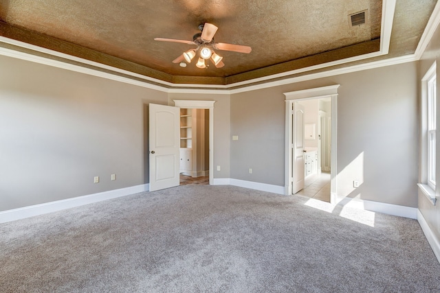 unfurnished bedroom featuring crown molding, a raised ceiling, light carpet, and ceiling fan