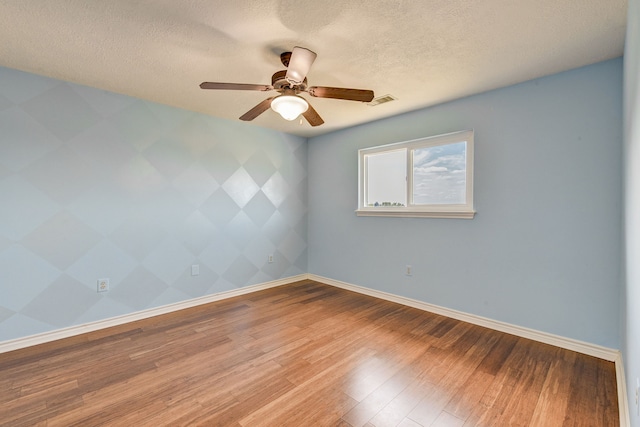 empty room featuring hardwood / wood-style floors, a textured ceiling, and ceiling fan