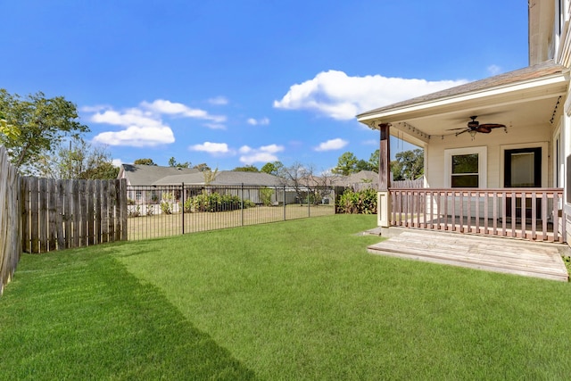 view of yard featuring a wooden deck and ceiling fan