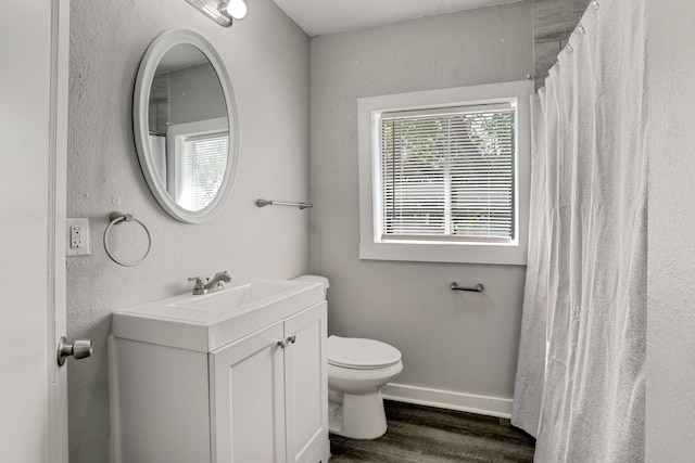 bathroom featuring hardwood / wood-style floors, vanity, and toilet