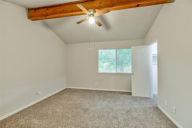 carpeted spare room featuring ceiling fan, a textured ceiling, and vaulted ceiling with beams