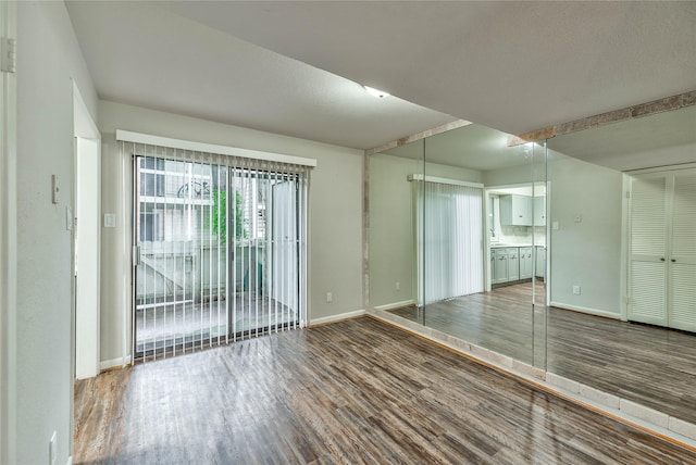 spare room with hardwood / wood-style flooring