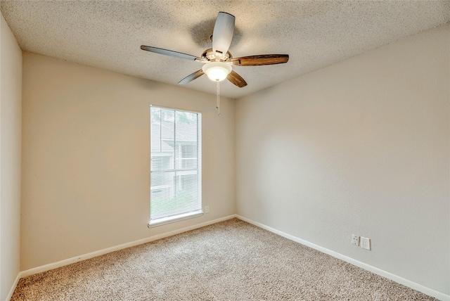 empty room featuring ceiling fan, carpet, and a textured ceiling