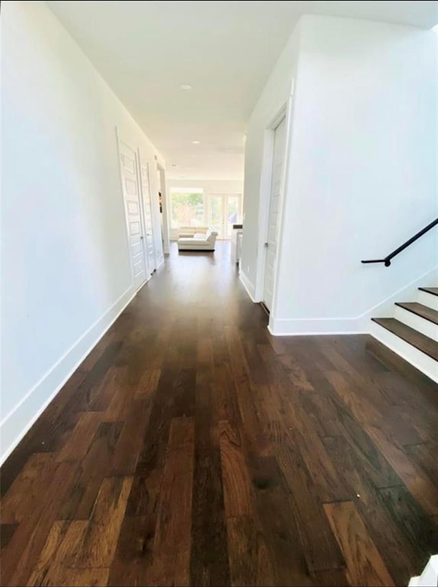 hall with dark hardwood / wood-style flooring