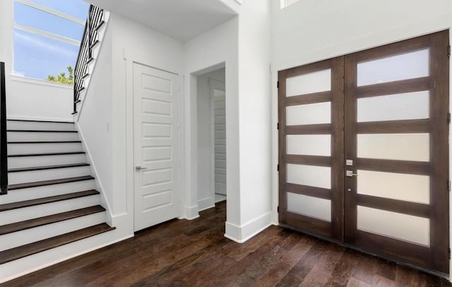 foyer featuring stairs, dark wood-style floors, baseboards, and french doors