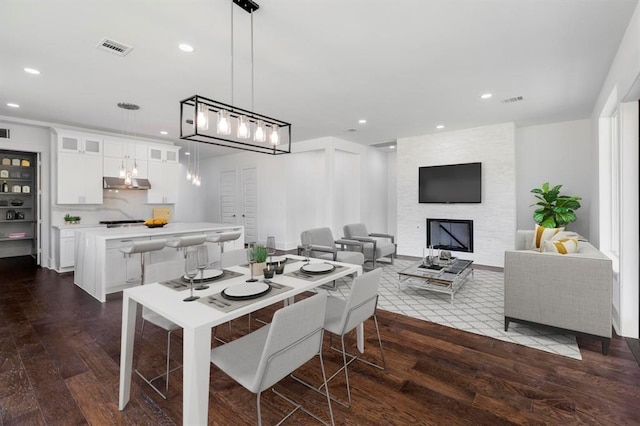 dining room featuring dark hardwood / wood-style floors and a fireplace