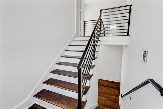 stairs featuring visible vents and wood finished floors