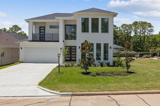 contemporary home featuring a garage, a balcony, and a front lawn