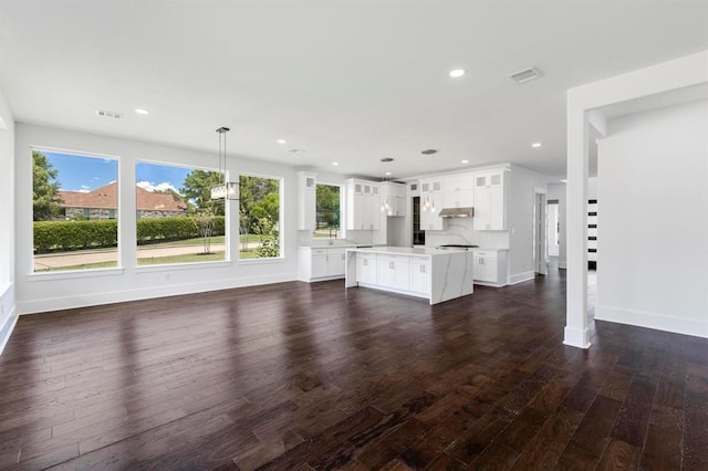 unfurnished living room featuring dark hardwood / wood-style floors