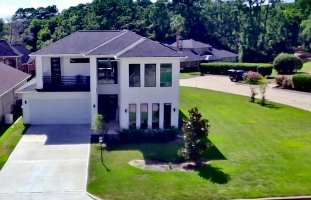 view of front of property with a garage and a front lawn