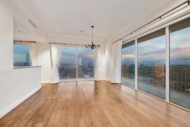 interior space featuring crown molding, light wood-type flooring, and a notable chandelier