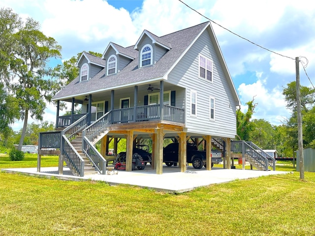 view of front of home with a carport, a porch, and a front lawn