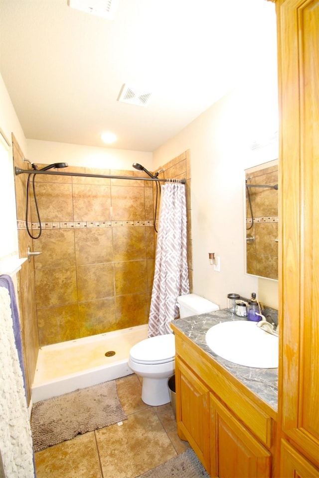 bathroom featuring curtained shower, vanity, and toilet