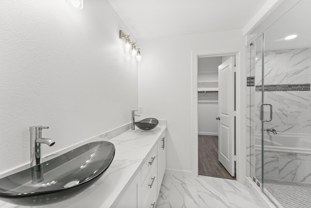 bathroom featuring hardwood / wood-style floors, vanity, and separate shower and tub