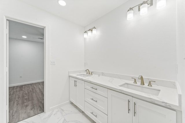 bathroom with ceiling fan, vanity, and hardwood / wood-style flooring