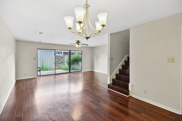 empty room featuring ceiling fan with notable chandelier and dark hardwood / wood-style flooring