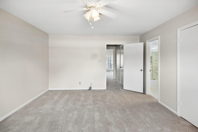 unfurnished room featuring ceiling fan and light colored carpet