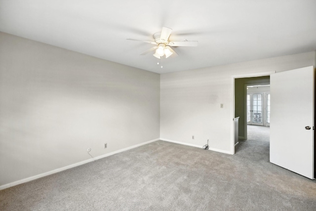 unfurnished room featuring ceiling fan, carpet floors, and french doors