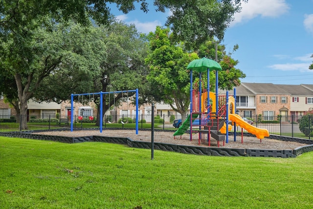 view of jungle gym featuring a lawn