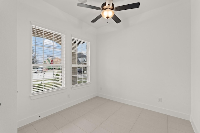 unfurnished room with ceiling fan and light tile patterned flooring