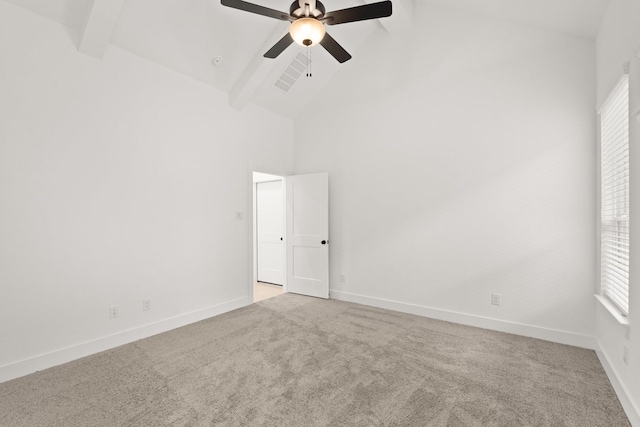 carpeted empty room with beamed ceiling, high vaulted ceiling, and ceiling fan