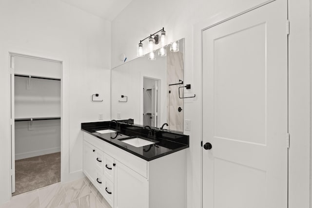 bathroom featuring a shower and vanity