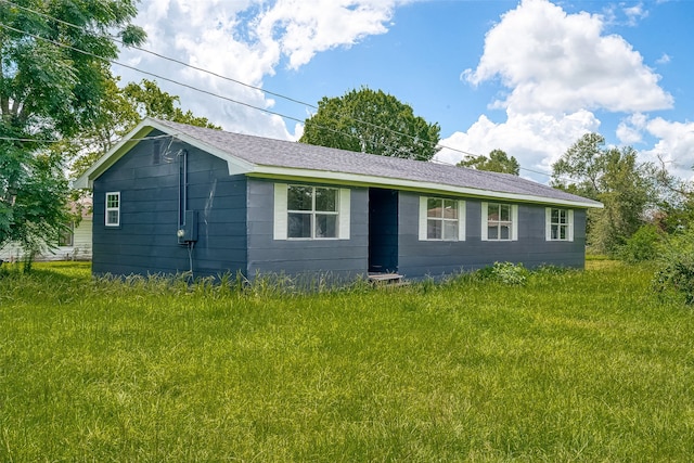 view of side of home featuring a yard