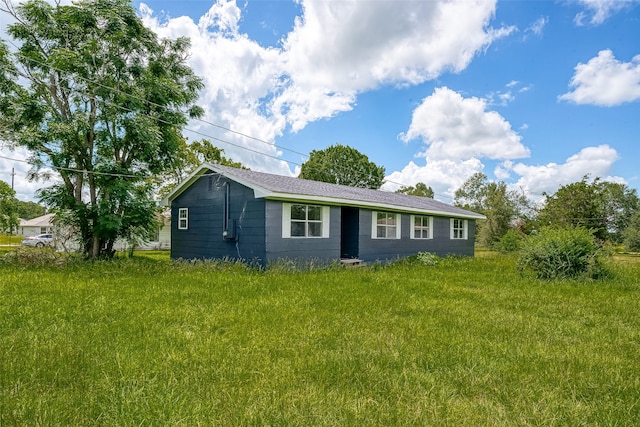 view of side of home with a lawn