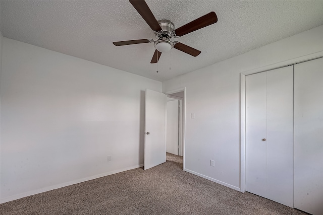 unfurnished bedroom with a textured ceiling, a closet, carpet, and ceiling fan