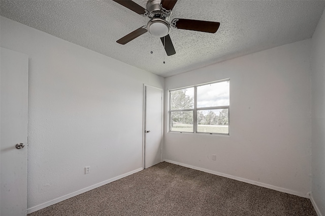 empty room featuring a textured ceiling, ceiling fan, and carpet floors