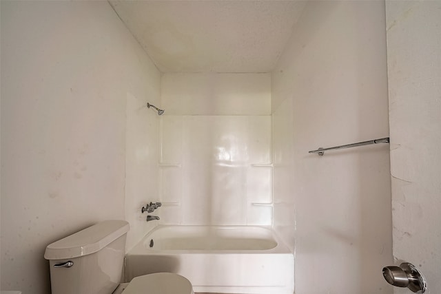 bathroom featuring tub / shower combination and toilet