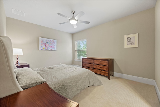 bedroom with ceiling fan and light carpet