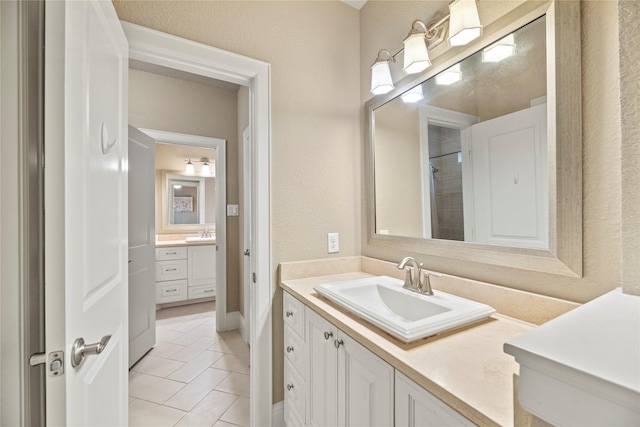 bathroom featuring tile patterned flooring and vanity