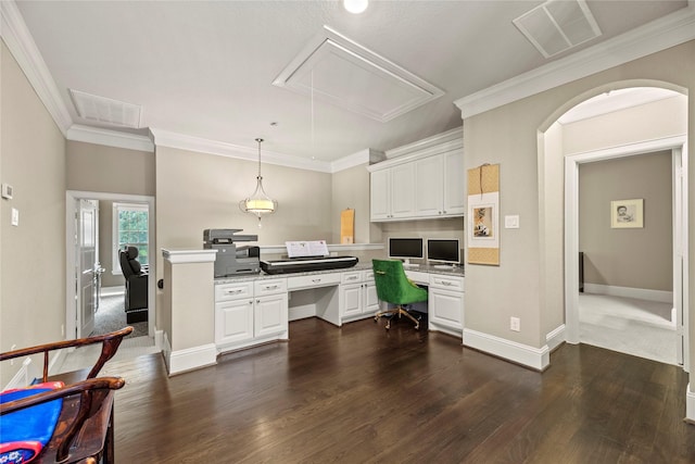 kitchen with white cabinets, built in desk, and ornamental molding