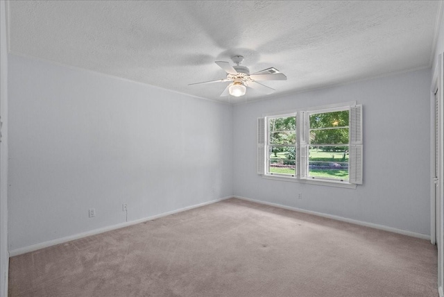 spare room featuring baseboards, a textured ceiling, a ceiling fan, and carpet flooring