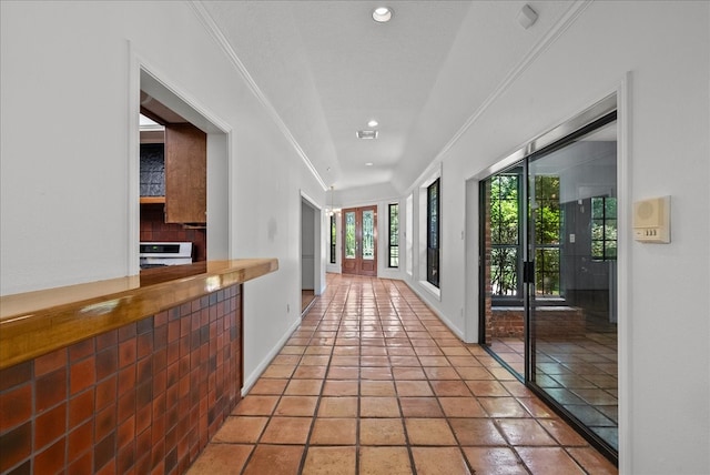 hall with french doors, crown molding, recessed lighting, light tile patterned flooring, and baseboards