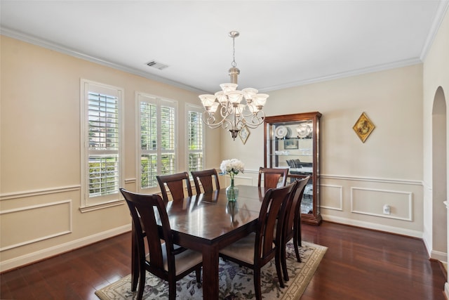 dining space featuring crown molding, a chandelier, and dark hardwood / wood-style floors