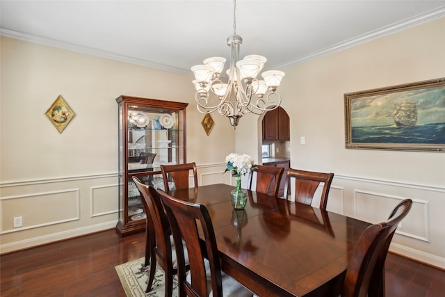 dining space with ornamental molding, dark wood-type flooring, and an inviting chandelier