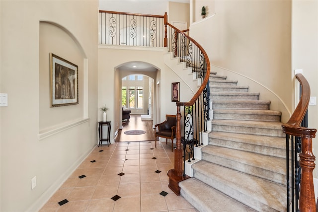 tiled entrance foyer featuring a high ceiling