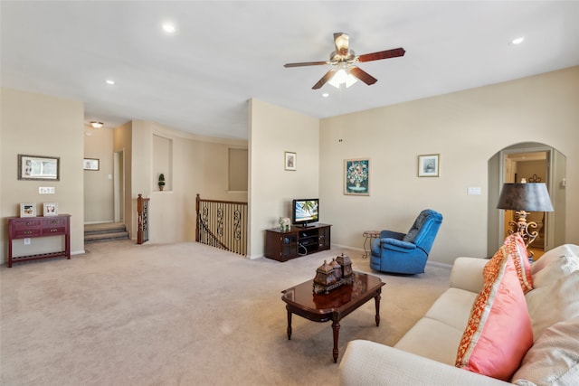 carpeted living room with ceiling fan