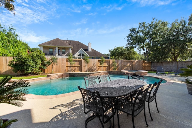 view of swimming pool with an in ground hot tub and a patio