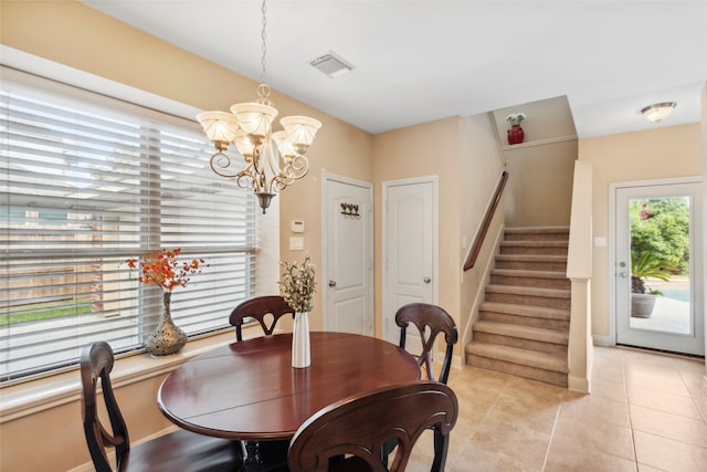 dining room featuring a notable chandelier and light tile patterned floors