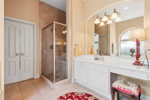 bathroom featuring tile patterned flooring, vanity, and a shower with door