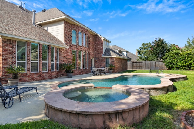 view of pool with a patio area and an in ground hot tub