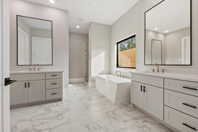 bathroom with vanity and shower with separate bathtub