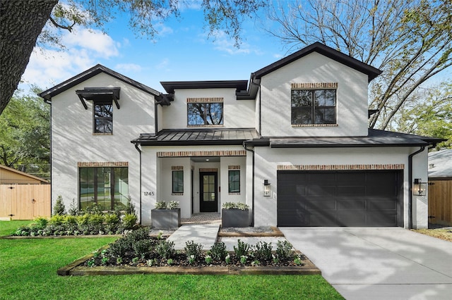 view of front of house featuring a garage and a front lawn